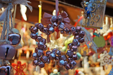 Christmas tree decorations made of glass, wood and fabric of different shapes and colors on the counter at the festive fair
