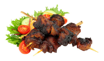 Barbecued burnt ends beef kebabs on wooden skewers with fresh salad isolated on a white background