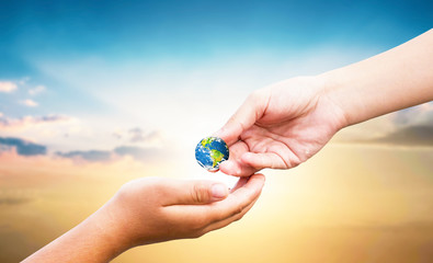 World Tourism Day concept: hand holding  earth globe give others over natural background