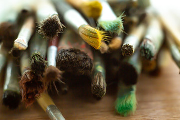 Old, Dirty Paint Brushes on wood table ground, Close up & Macro shot, Selective focus, Stationery concept
