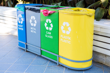 Selective collection of garbage colored containers with inscriptions in Turkish and English for...
