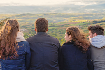 Christian worship and praise. Group of friends hugging outdoors at sunset.