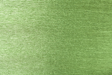 Textural of green background of wavy corrugated paper, closeup.