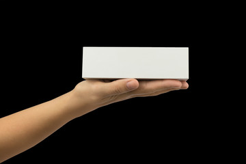 white gift box on woman's hand isolated on black background