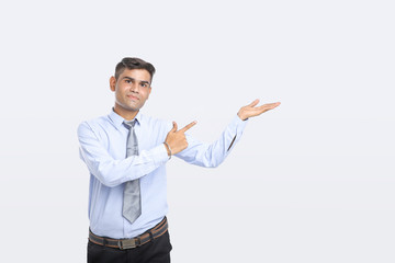 Young Indian Man Showing Direction With Hand