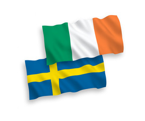 National vector fabric wave flags of Ireland and Sweden isolated on white background. 1 to 2 proportion.