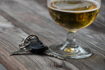 Drinking and driving - Vehicle keys near a glass beer