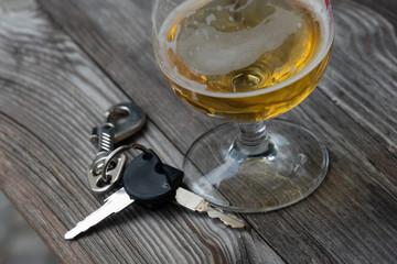 Drinking and driving - Vehicle keys near a glass beer