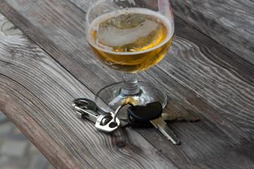 Drinking and driving - Vehicle keys near a glass beer