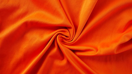 orange silk fabric background, texture of sportswear shirt