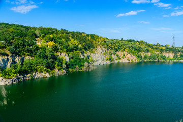 Fototapeta na wymiar Beautiful lake in the abandoned granite quarry on summer