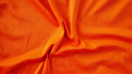 orange silk fabric background, texture of sportswear shirt