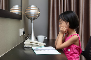 Asian Little Chinese Girl doing homework