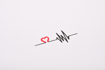 Heart rhythm hand drawing, electrocardiogram, heart beat pulse line concept on white paper...