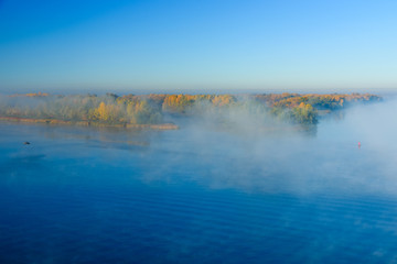 Fototapeta premium Fog over the water on a river Dnieper on autumn