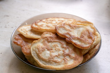 fresh pancakes on a glass dish. authentic homemade food. background backdrop.