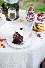 Delicious chocolate cake, red velvet in a glass, wild flowers, berries.