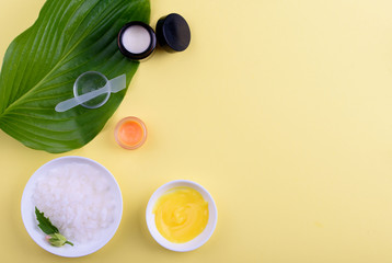 Beautiful layout of cosmetic products on a yellow background. Natural cosmetics for face and body.