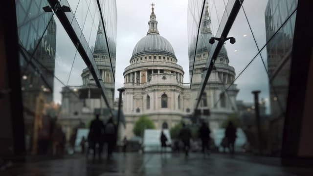 People are walking in front of St Paul's Cathedral in London, UK