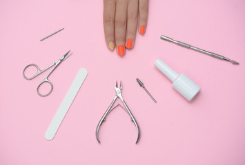Beautiful well-groomed female hands, after manicure and and manicure tools.
