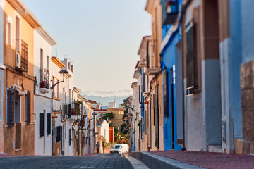 Fototapeta na wymiar Old town of Denia with narrow streets and coloured houses.