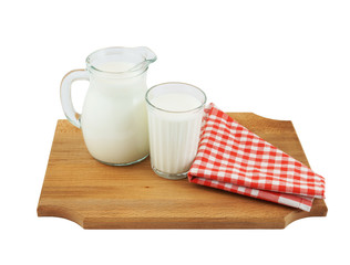 Milk in pitcher and glass on wooden board isolated