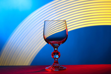 Glass wine glass on table on abstract background