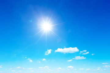 Fototapeta na wymiar sun in blue sky background with tiny clouds
