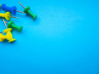 Red, green, yellow, white and blue plastic buttons on a blue background.