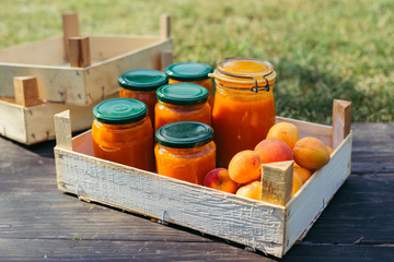 apricot jam in jars on wooden board outdoor