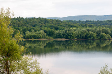 beautiful summer lake against the background of high mountains and blue sky