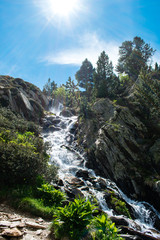 Fototapeta na wymiar Landscape with waterfall in the mountains in summer at Parc Natural del Comapedrosa, Arinsal, Andorra