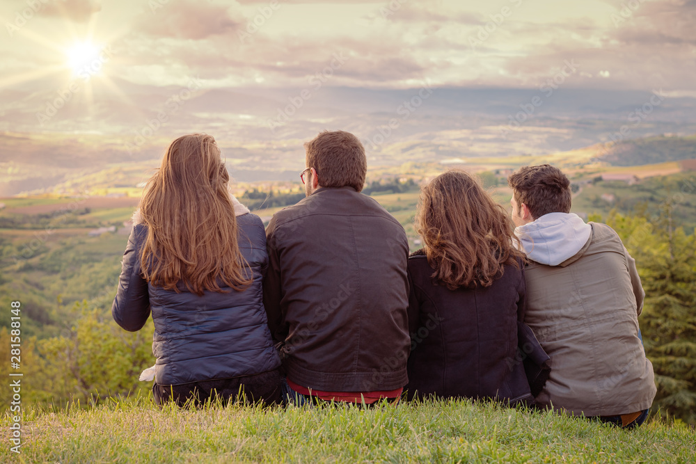 Poster christian worship and praise. group of friends hugging outdoors at sunset. - Posters