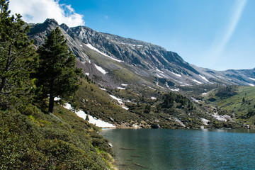 Mountain lake Estany de les Truites in Andorra Pyrenees, La Massana, refugi de coma pedrosa