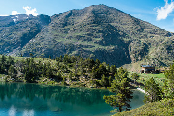 Fototapeta na wymiar Mountain lake Estany de les Truites in Andorra Pyrenees, La Massana, refugi de coma pedrosa