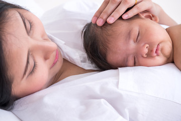 Fototapeta na wymiar Sleeping newborn baby on mother's body.
