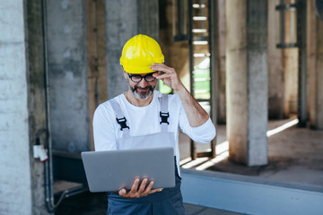 worker using laptop on construction site