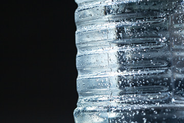 Close up of a sparkling water bottle with condensation on it
