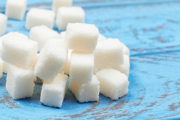 Group of refined white sugar cubes close up