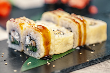 Japanese food restaurant, sushi and rolls on dark background