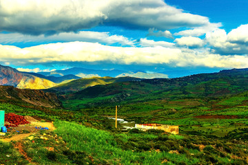 Beautiful mountain landscape. View of the mountains and the valley with land, sky and clouds