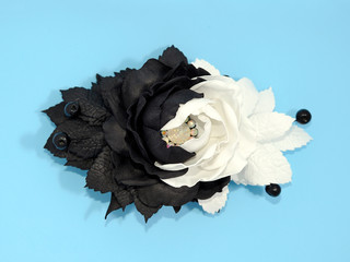 Black and white kanzash flowers isolated on blue background