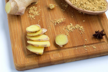 Fototapeta premium slices of fresh ginger on wooden background