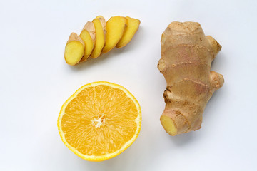 Fototapeta na wymiar slices of lemon and fresh ginger isolated on white background