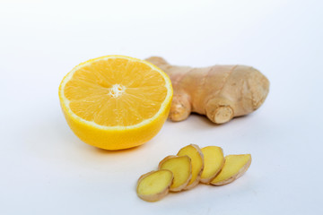 sliced ginger with yellow lemon on a white background