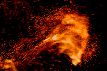 flame of fire with sparks on a black background