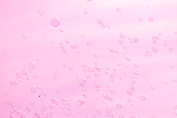 soap bubbles on a pink background