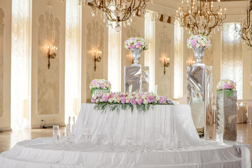 Wedding decor banquet hall in the palace. White and light pink fresh flowers