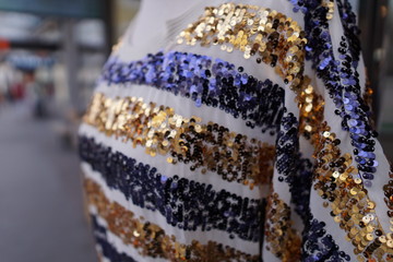 Sequin clothes blue yellow white dress with blurred background fashionable clothing glamour party shiny gown 