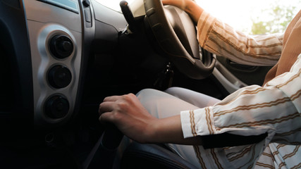 portrait of a Muslim hijab Woman turning on her car air conditioning system